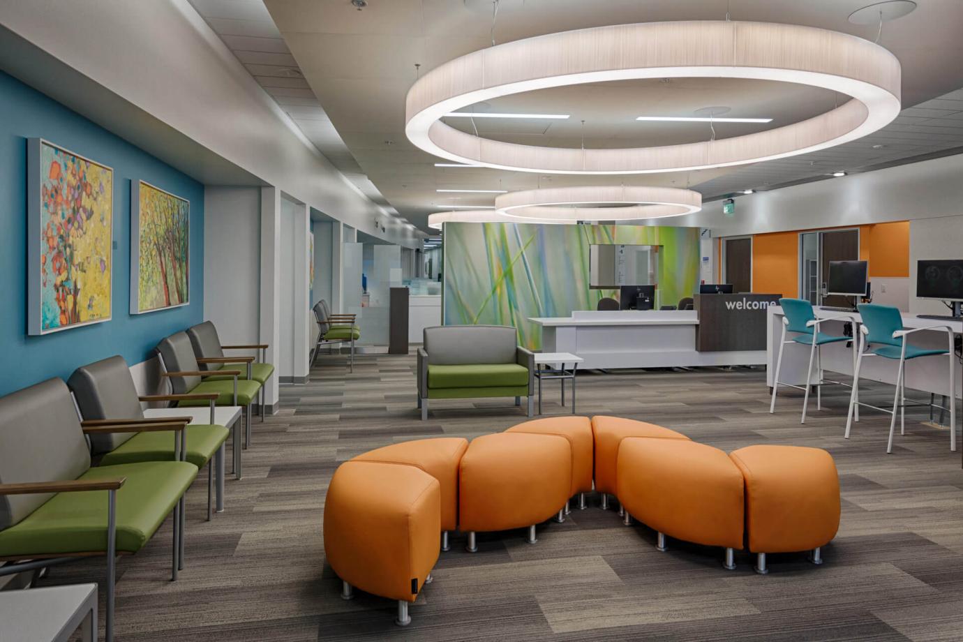 Patient waiting area with artwork and a variety of seating options
