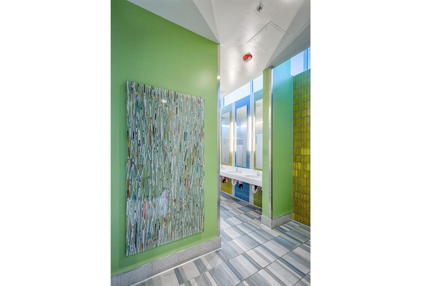 Cultural references extend to areas of high public use that are often overlooked. The restrooms incorporate tiles commonly seen In people’s homes. And the entry panel features colorful paper strips arranged in bamboo-like groves.